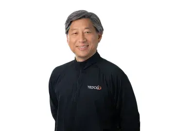 Jean-Luc Park in black jacket with Nvidia logo, standing against a white background.