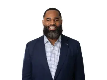 Jason Harris in a navy blazer on a white background.