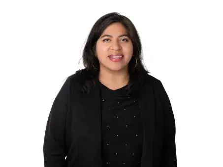 Valery Gutierrez smiling woman in black top on white background.