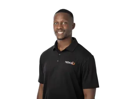 Claudius Taylor in black polo shirt on white background.